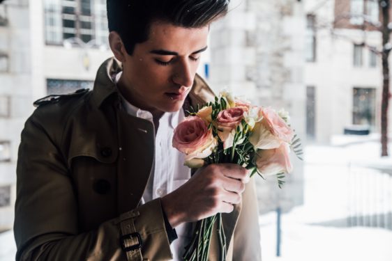 Man holding flowers, possibly going on a date after a divorce